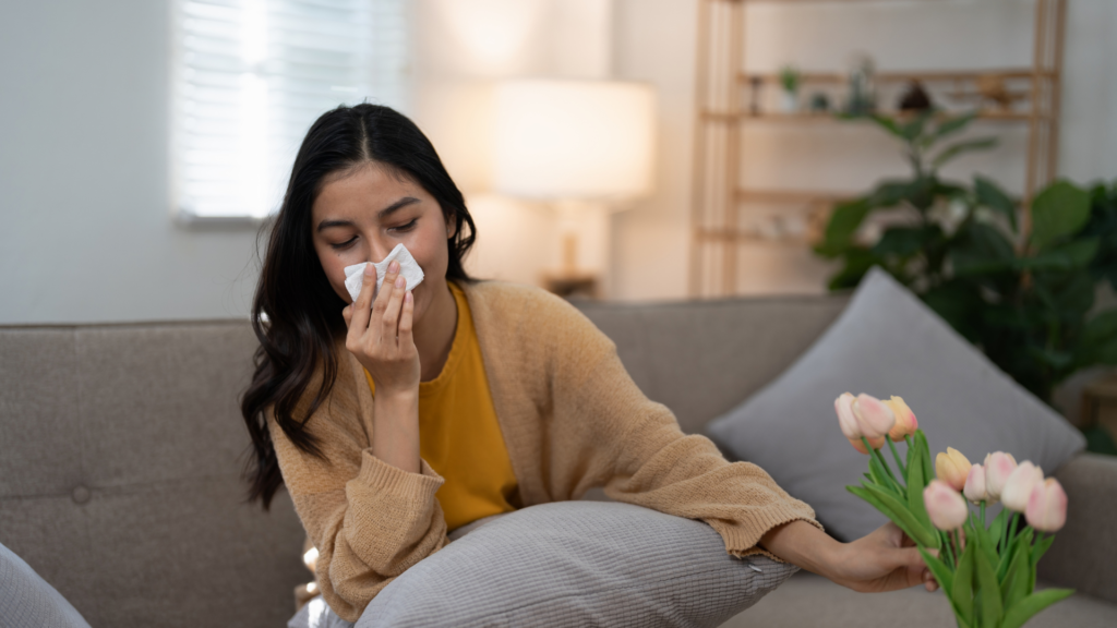woman blowing her nose at home
