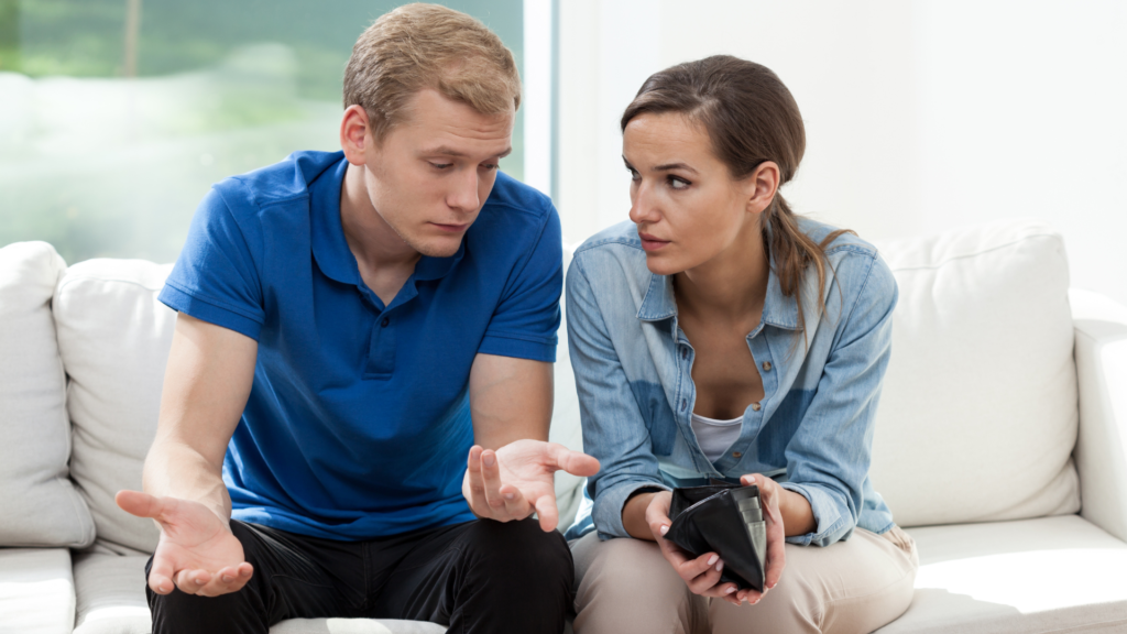 Couple holding wallet are stressed out about money.