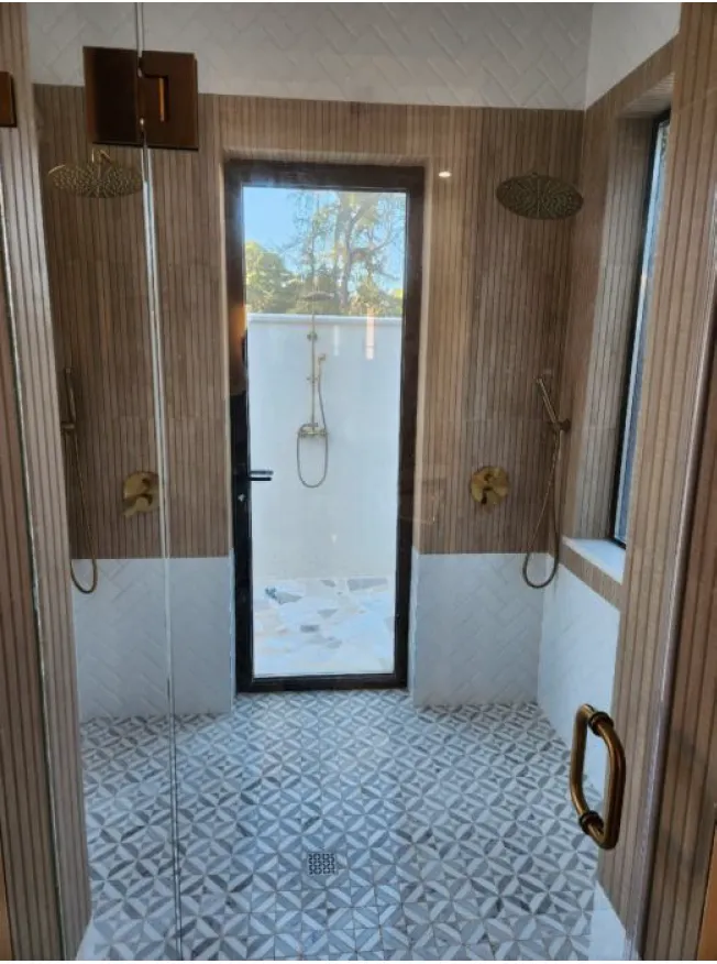 custom shower build with wood tile
